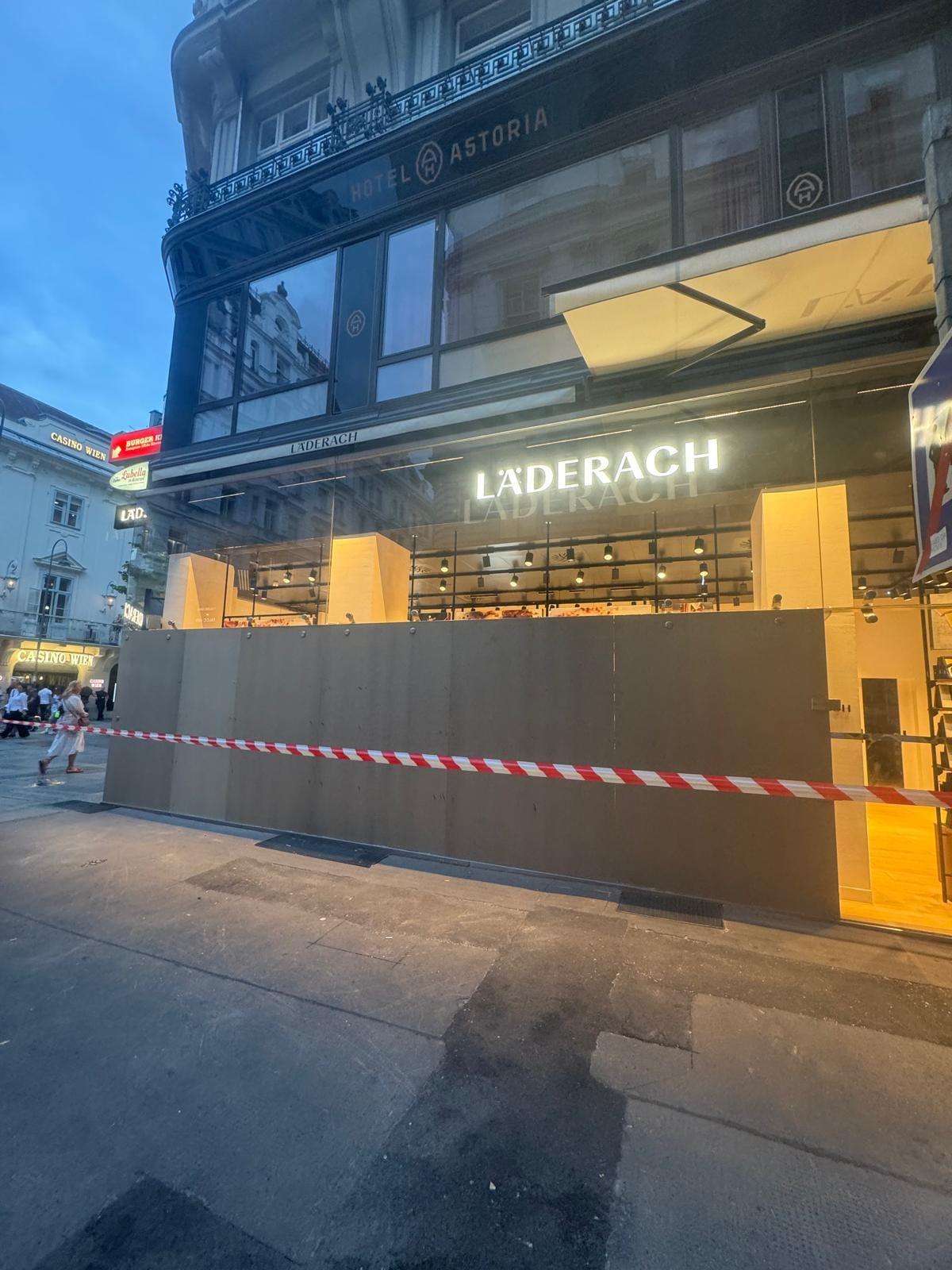 Zerbrochene Glasfassade Läderach Kärntner Straße nach Vandalismus, Polizeiabsperrung